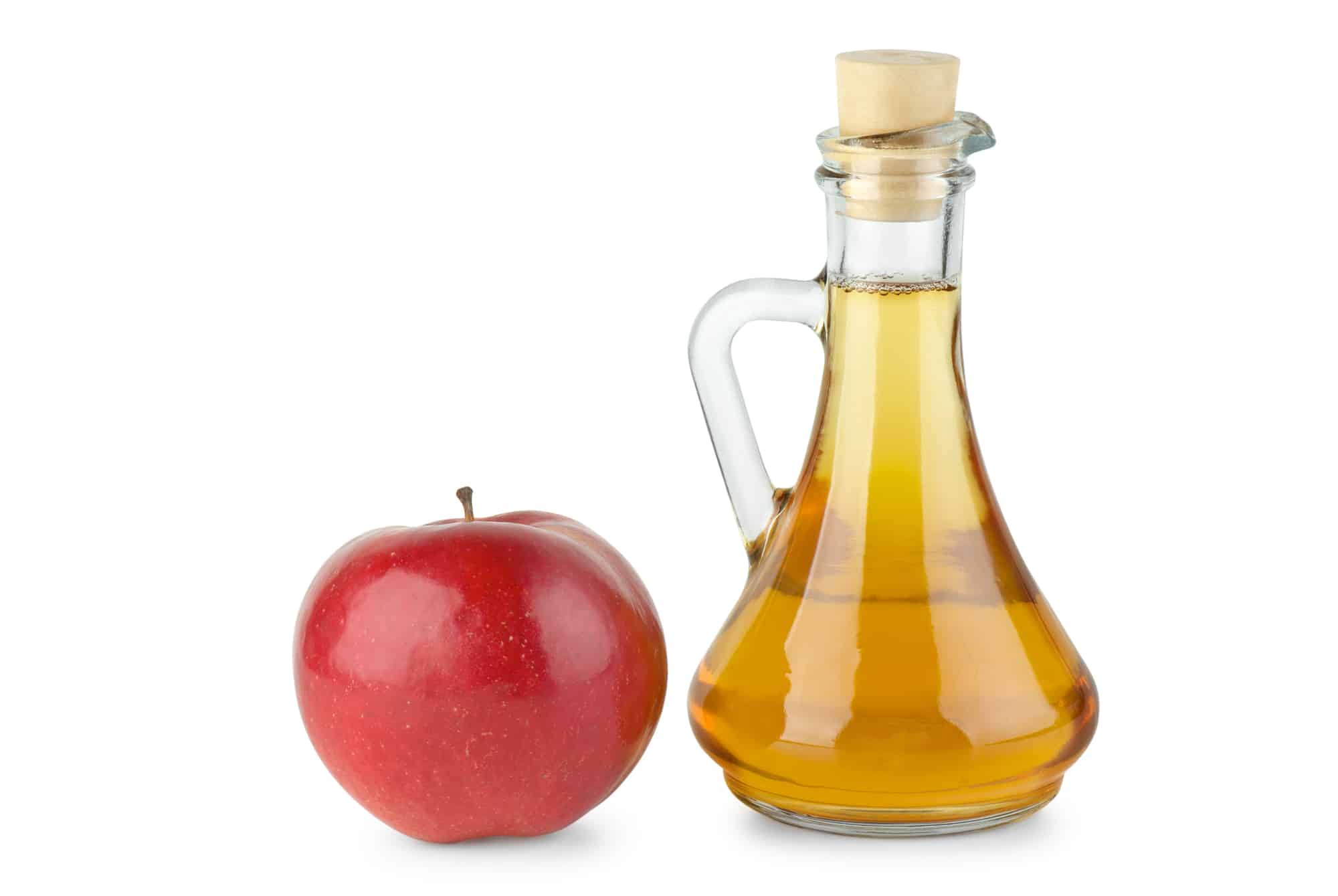 Decanter with apple vinegar and red apple isolated on the white background