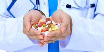 doctor holding prescription drugs