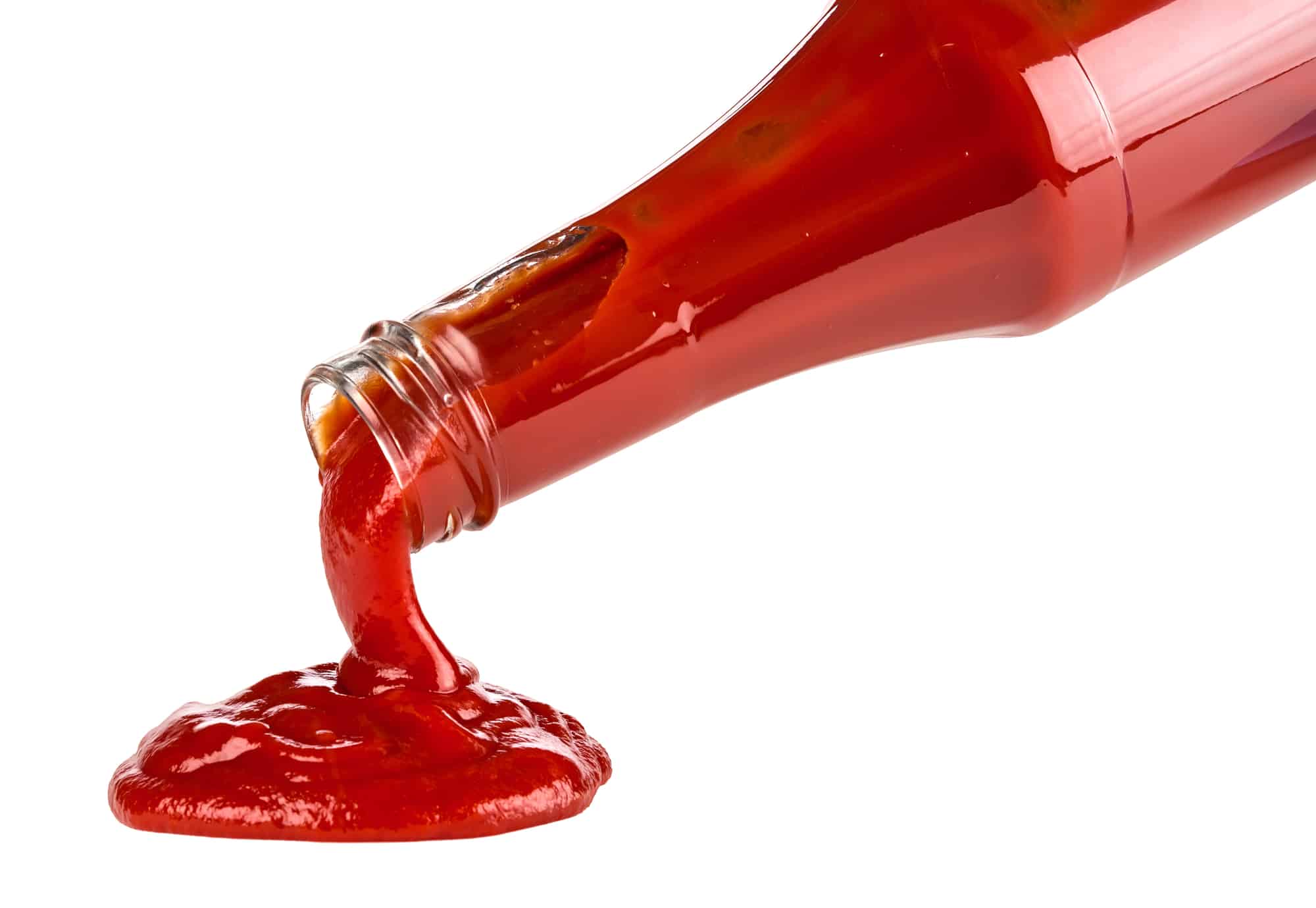 Ketchup pouring out on table