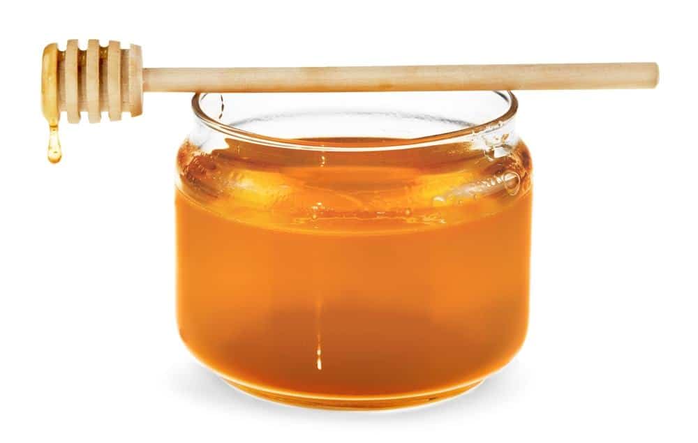 photo of jar of honey and honeycomb