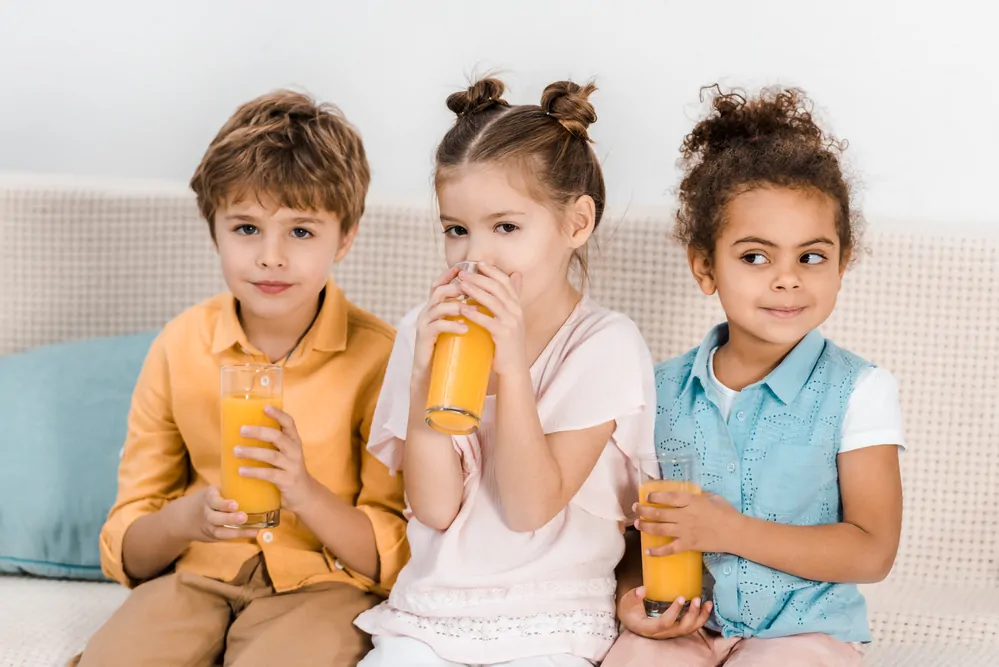 children drinking orange juice