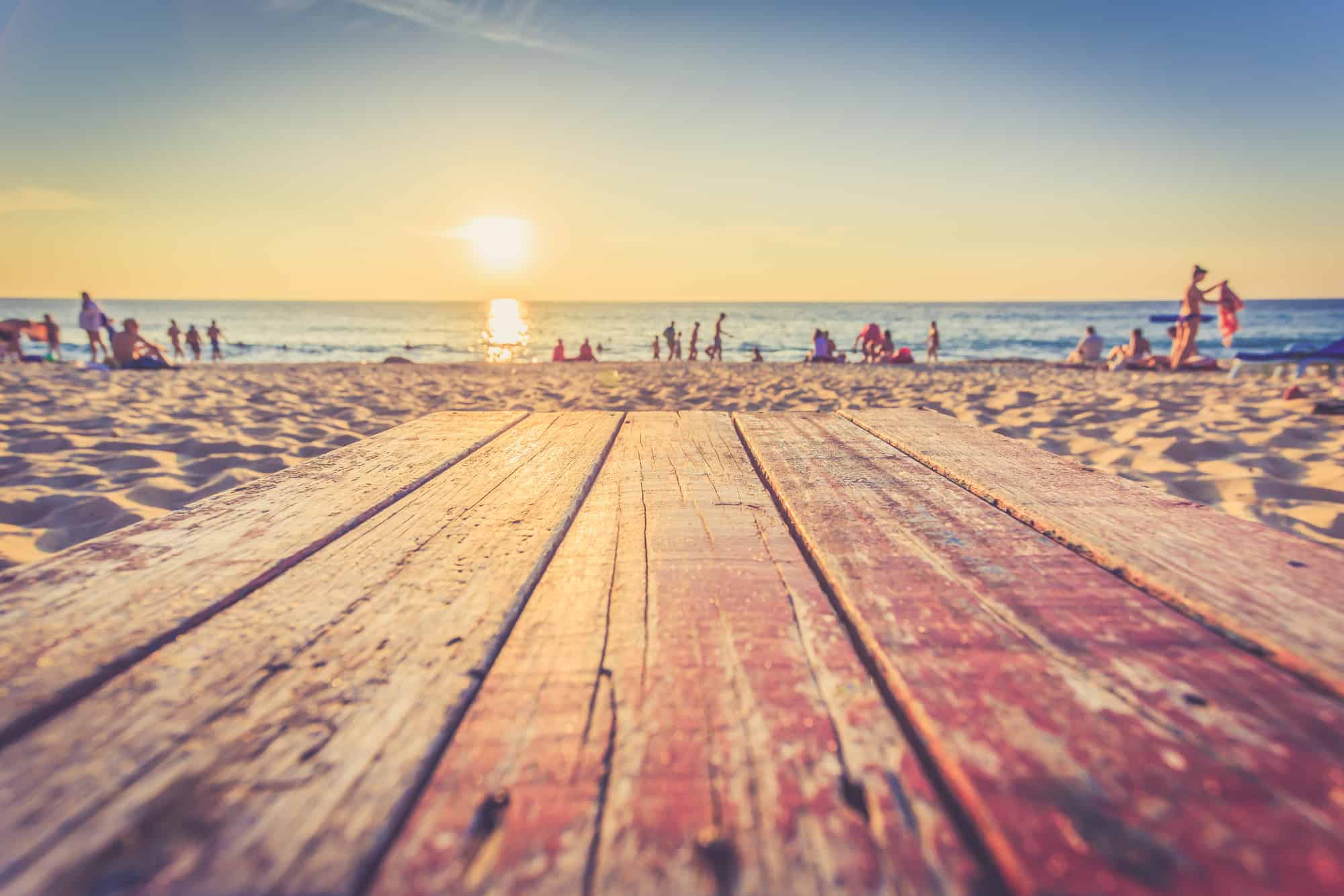 Wooden plank leading to a beach scene