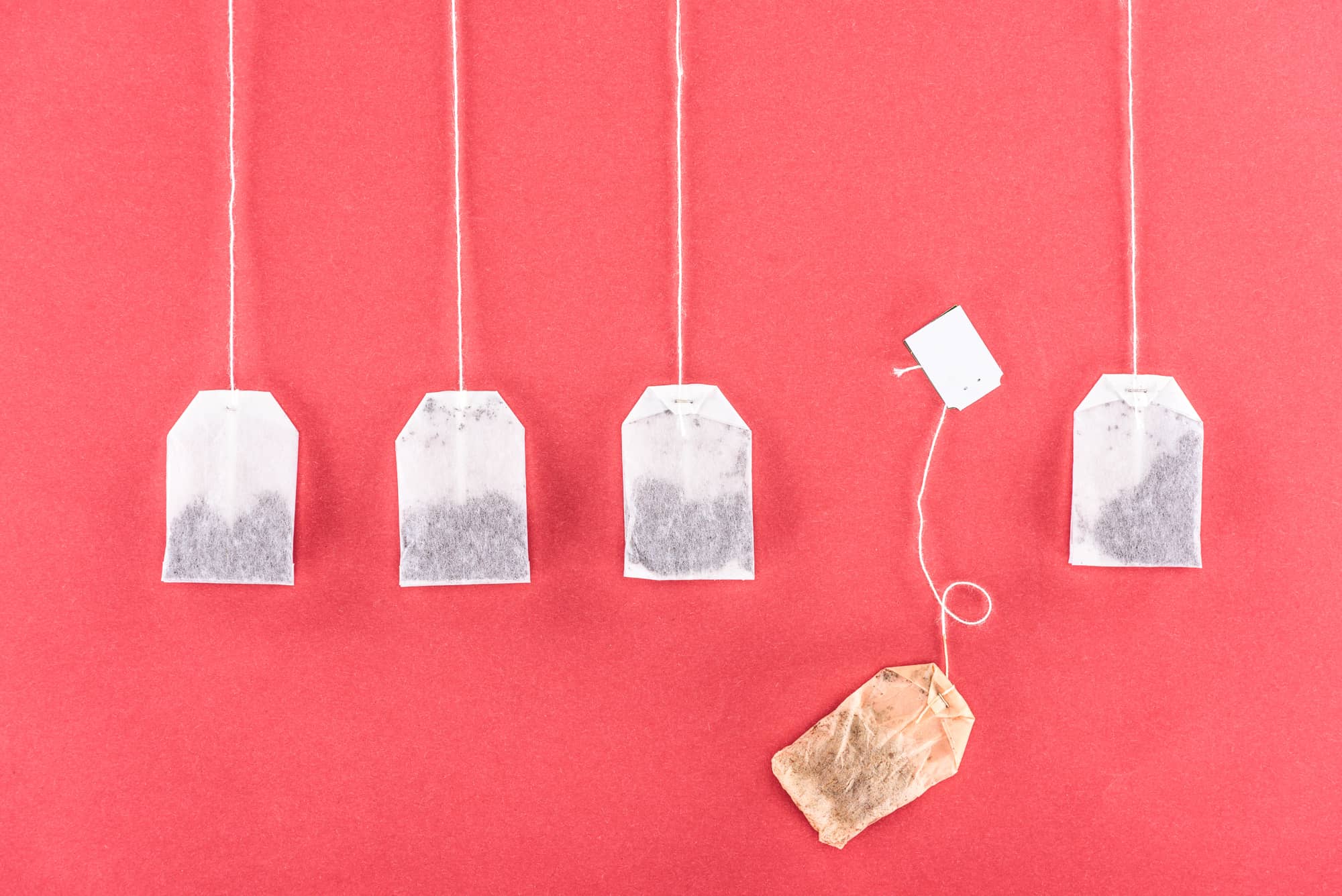 tea bags against a pink wall