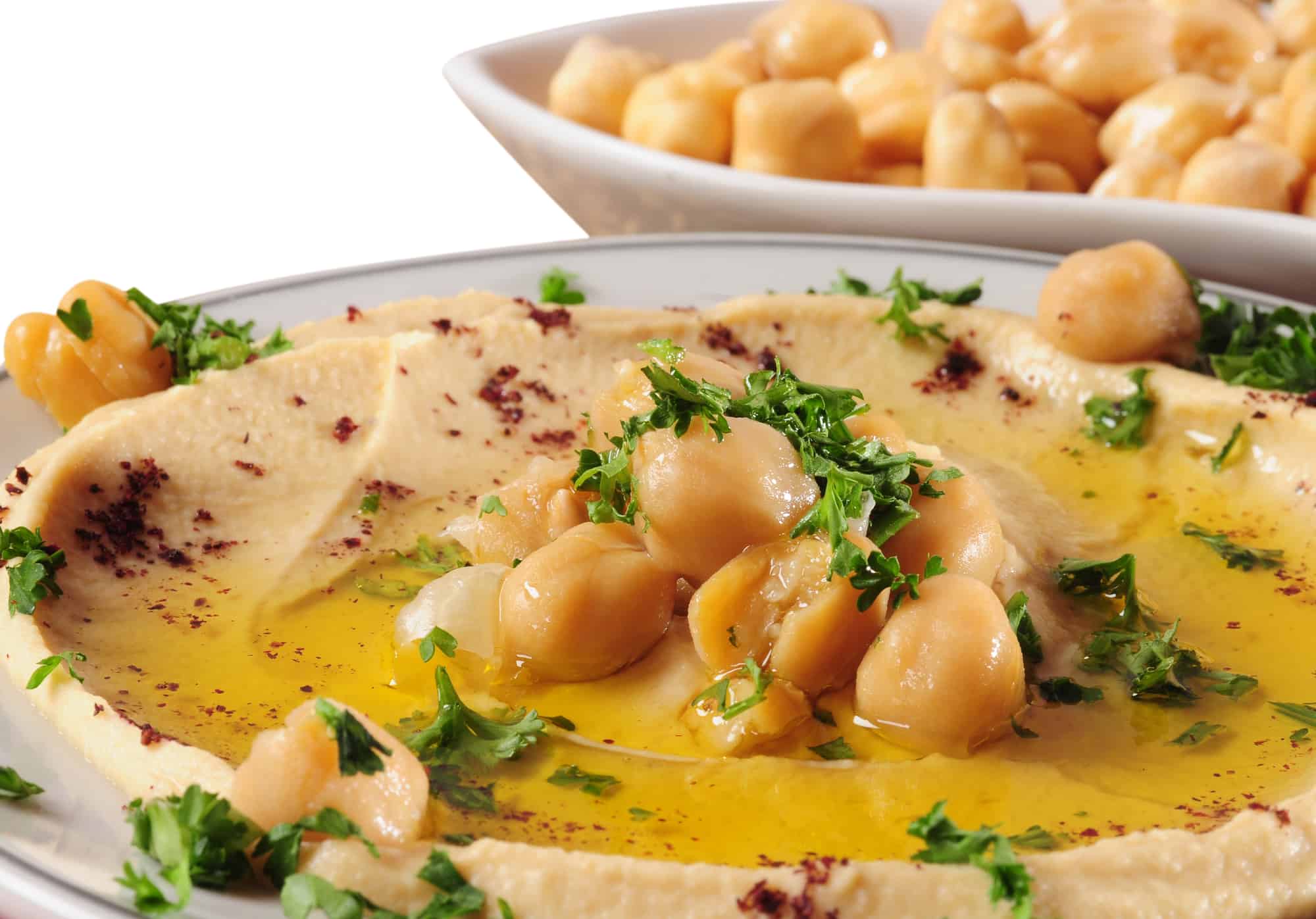 Closeup of hummus with olive oil and parsley