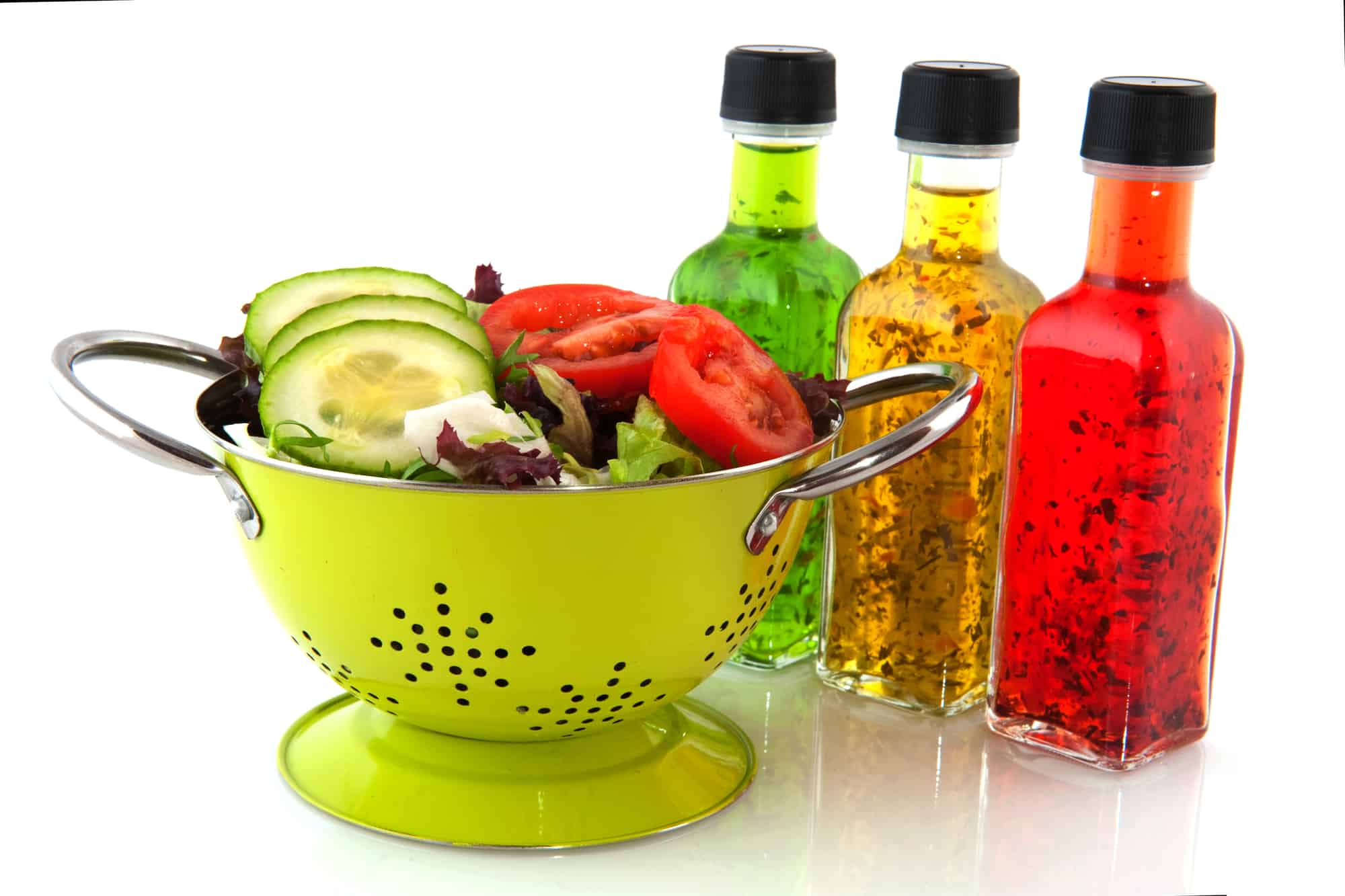 Colorful dressing with herbs in glass bottles