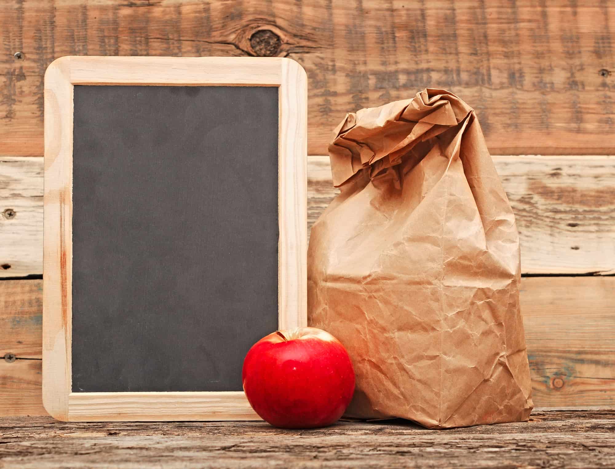 brown paper bag with apple