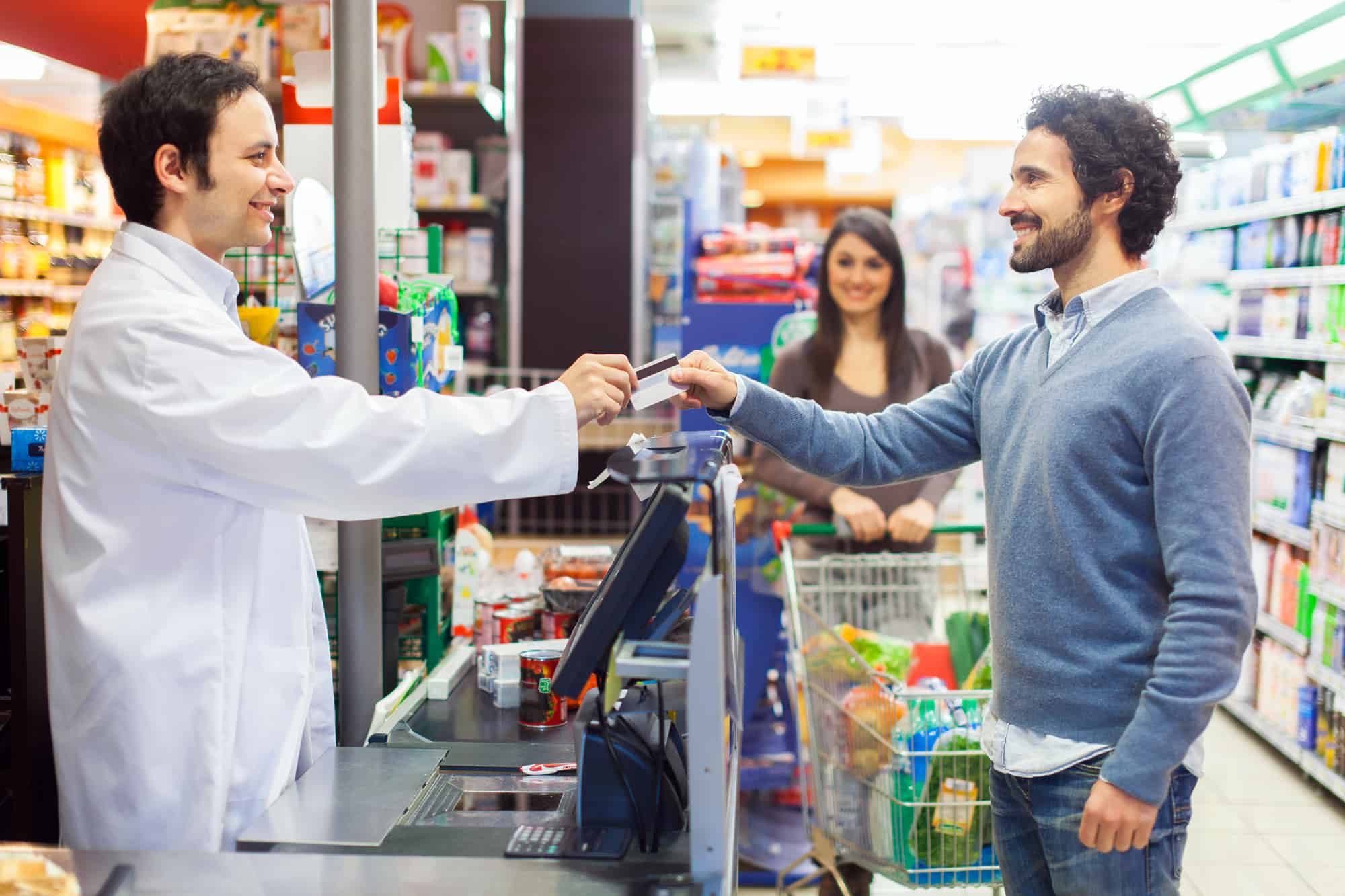 man and woman in grocery store