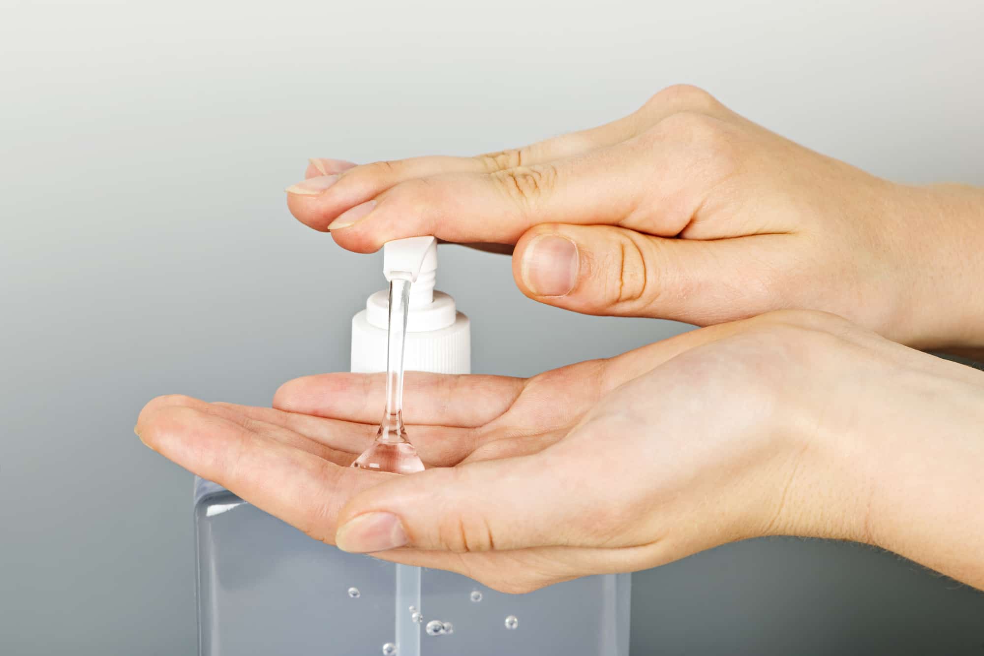 woman's hands pumping out organic hand sanitizer