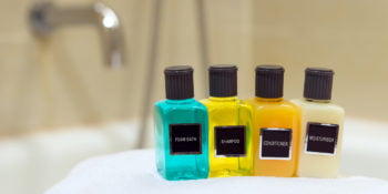 Foam bath, shampoo, conditioner and moisturizer in hotel bathroom