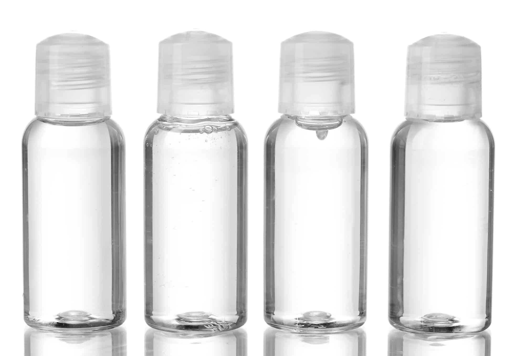 Hotel cosmetic single-use plastic shampoo bottles isolated on white