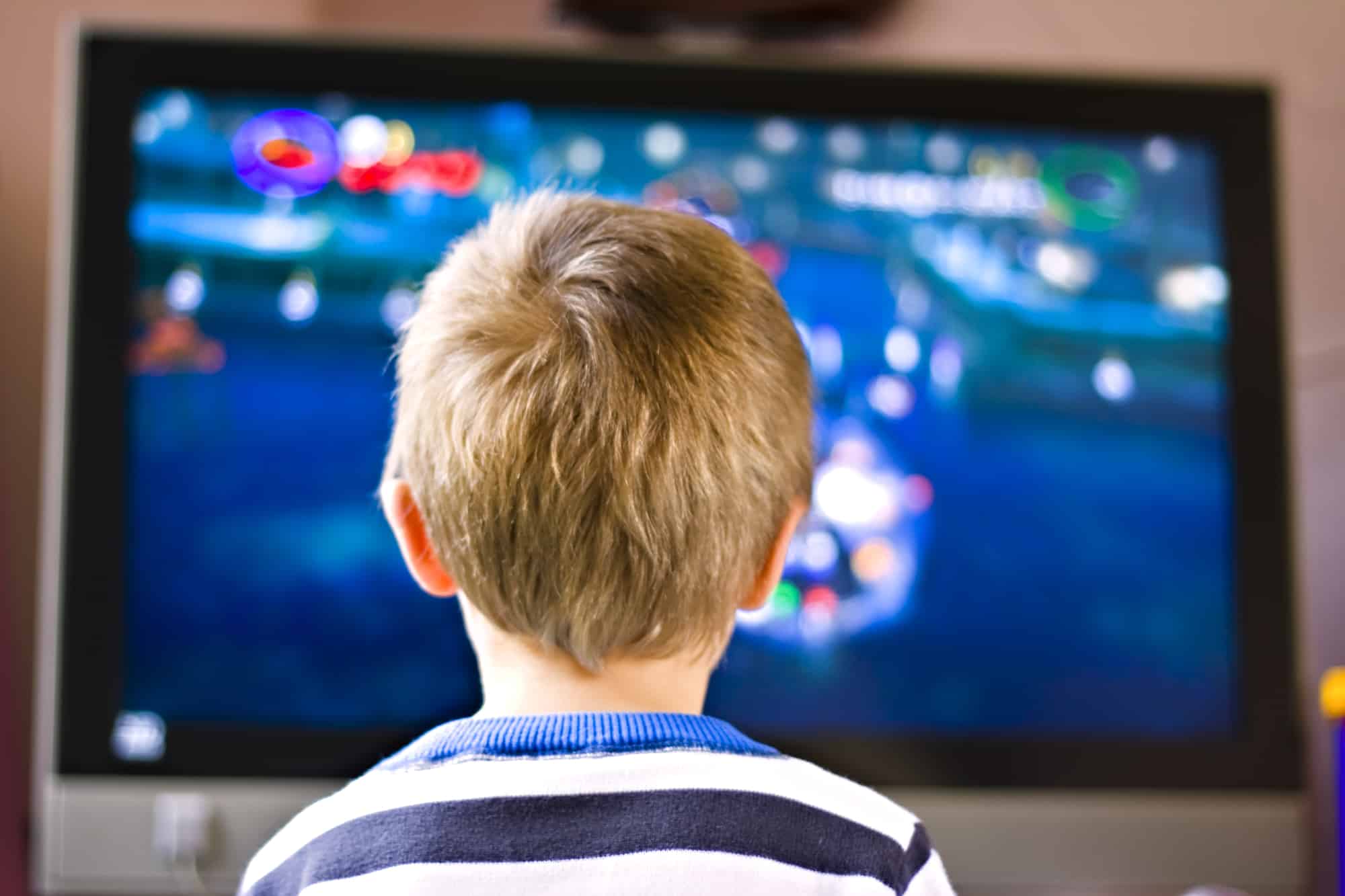 child sitting in front of toxic american television with fire retardants