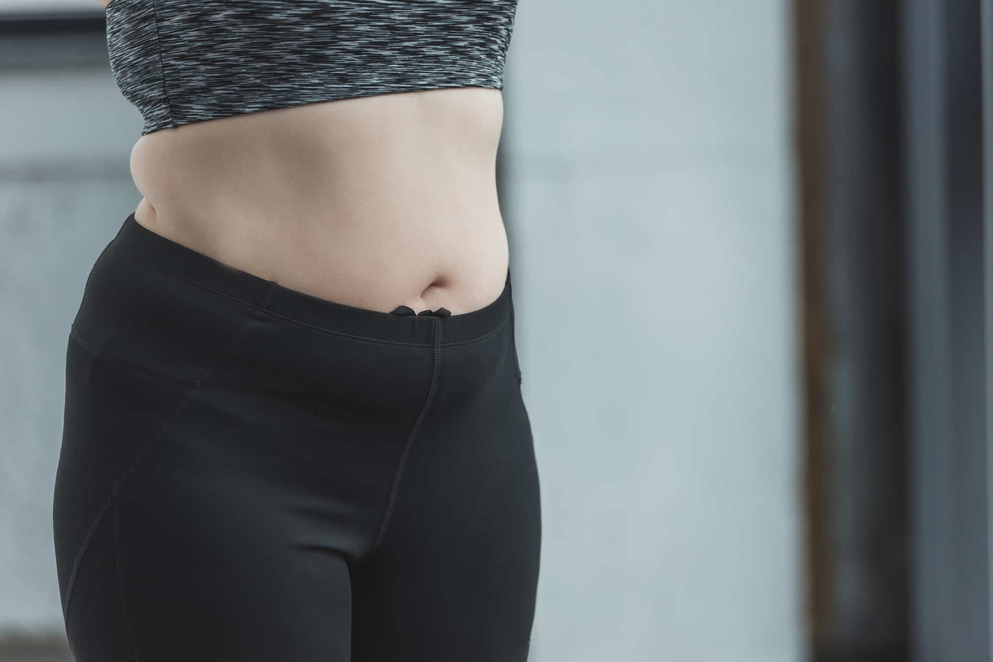 woman standing in front of door with belly 