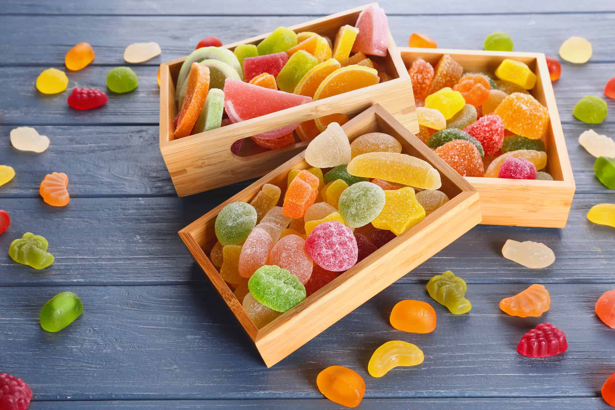 Composition of organic jelly candies on wooden background