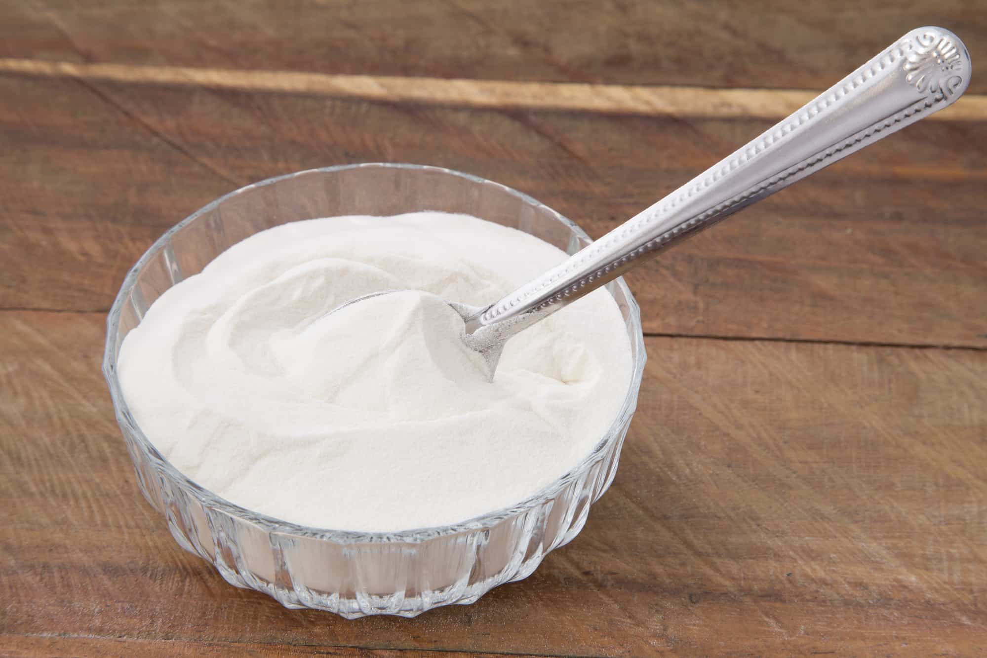 spoon in bowl of grassfed collagen on wooden table