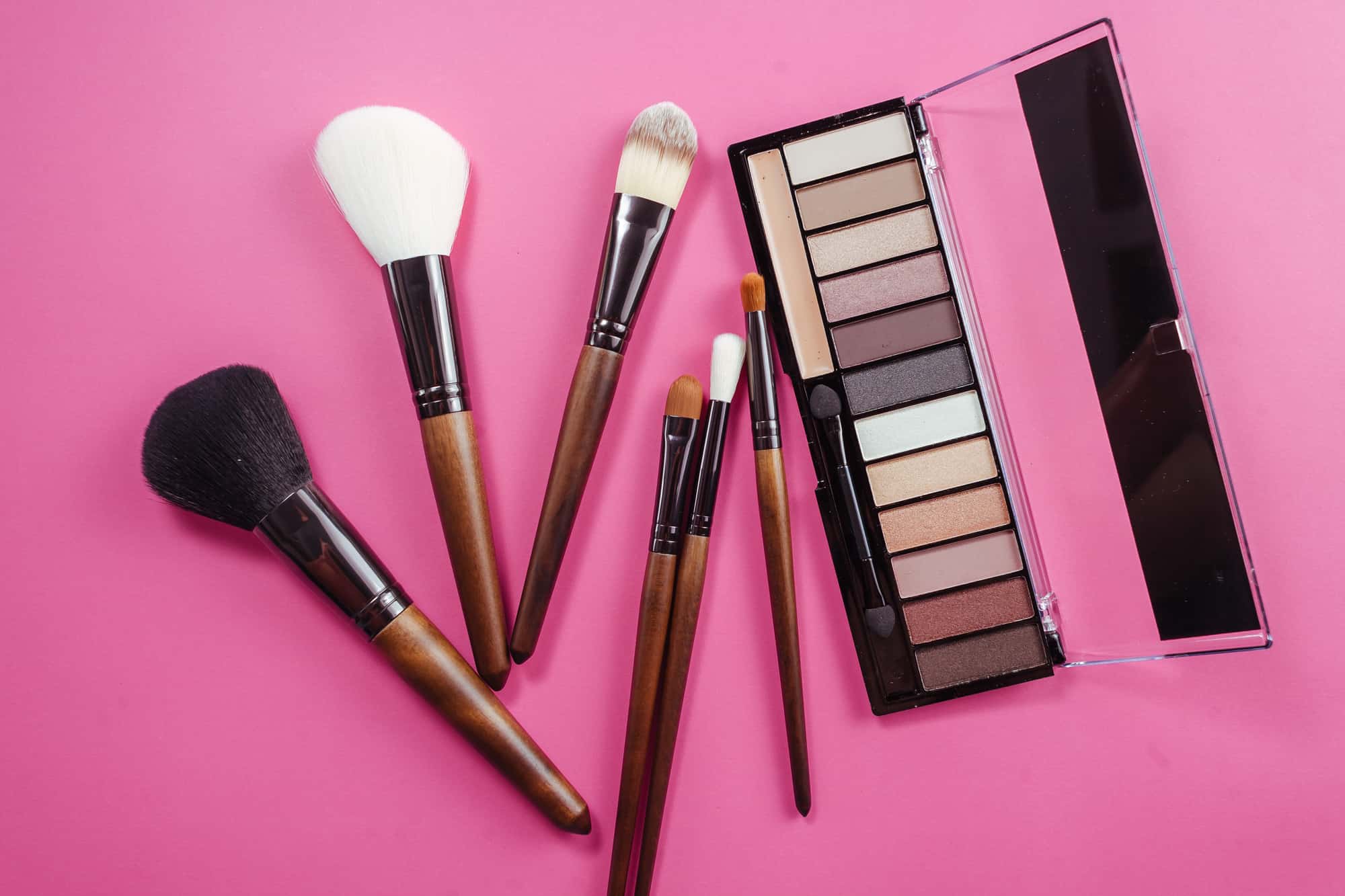 Set of colorful cosmetics on pink background