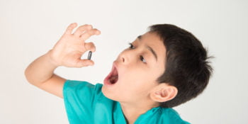 Giving kids medicine, boy try to swallow pills