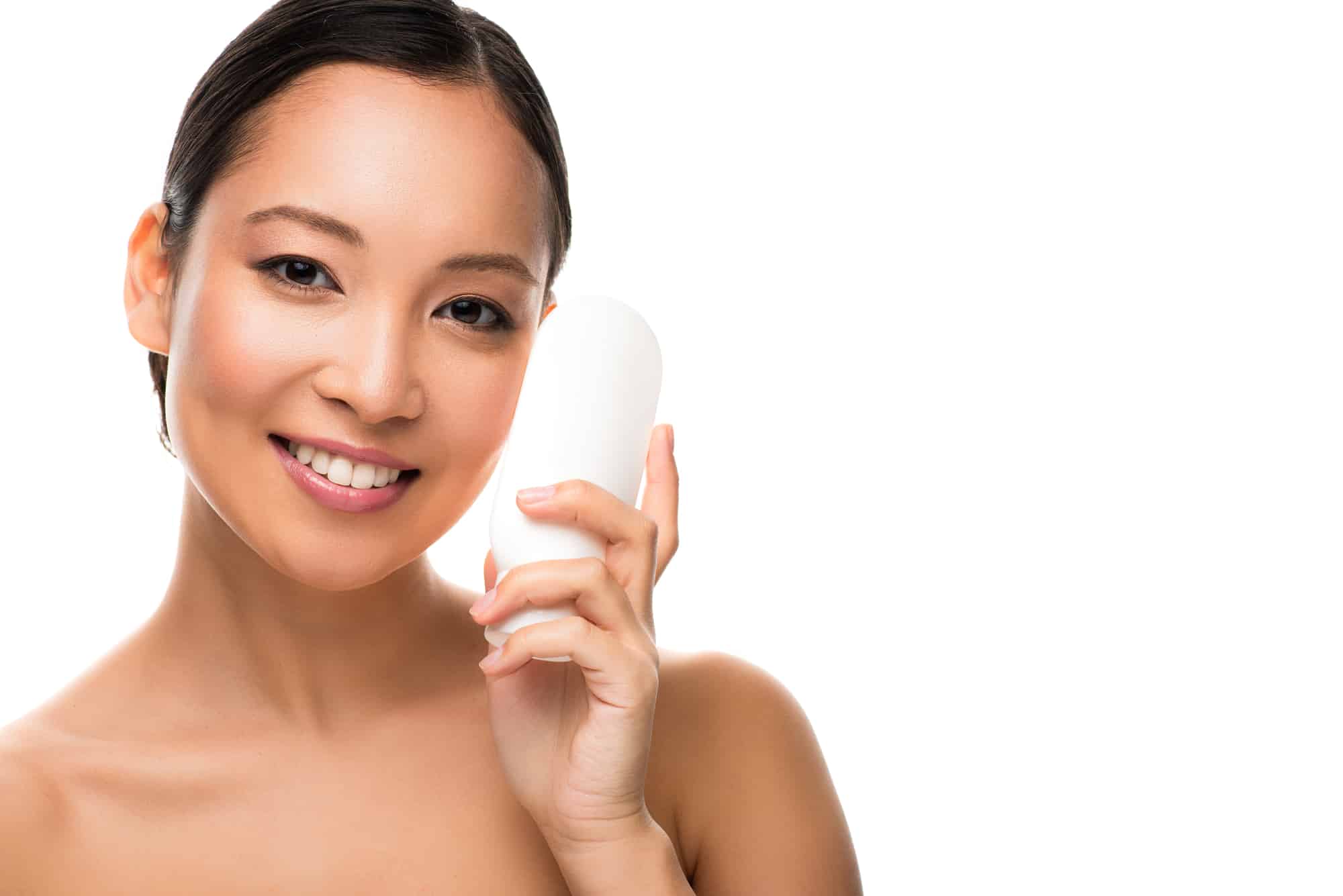 beautiful asian woman holding up bottle of lotion 