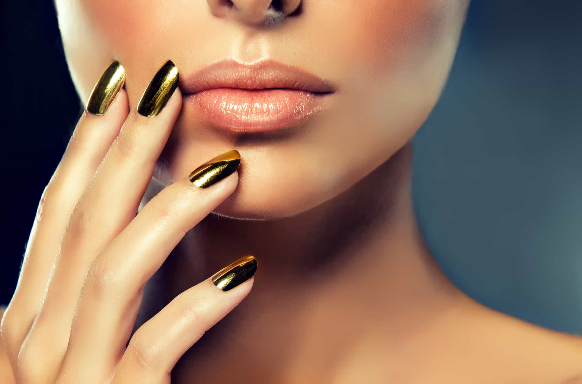 beautiful woman wearing gold non-toxic nail polish