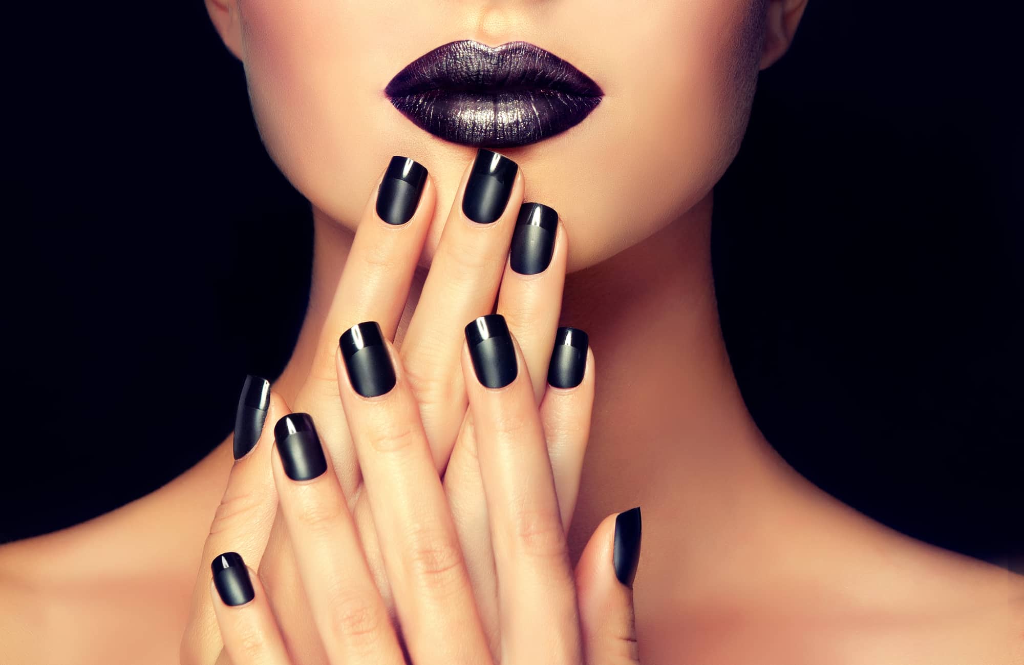 woman with black 9-free non-toxic nail polish and lipstick