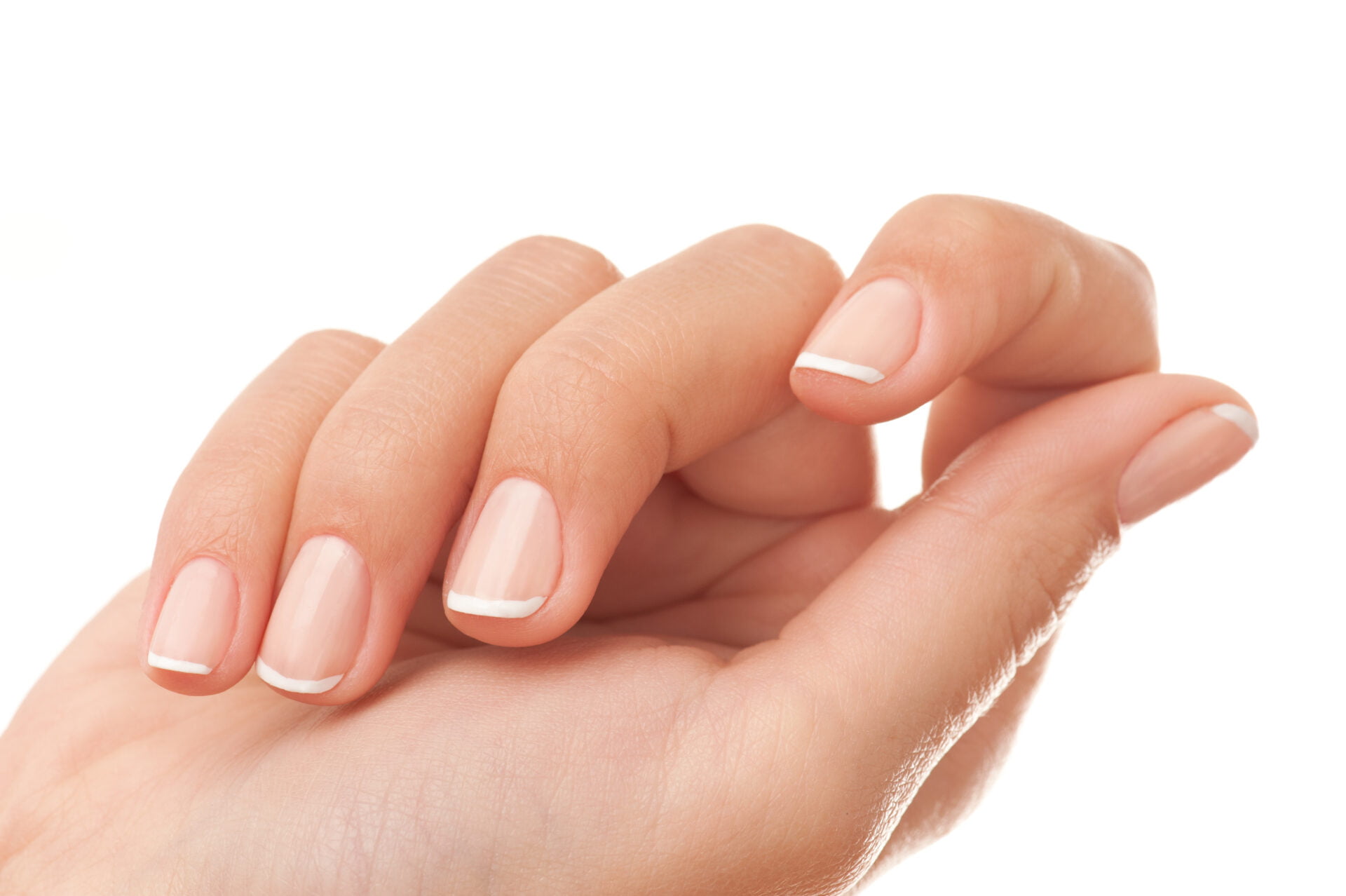 Close-up of womans hand with French manicure isolated on white.