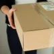 Woman picking up a parcel at her flat