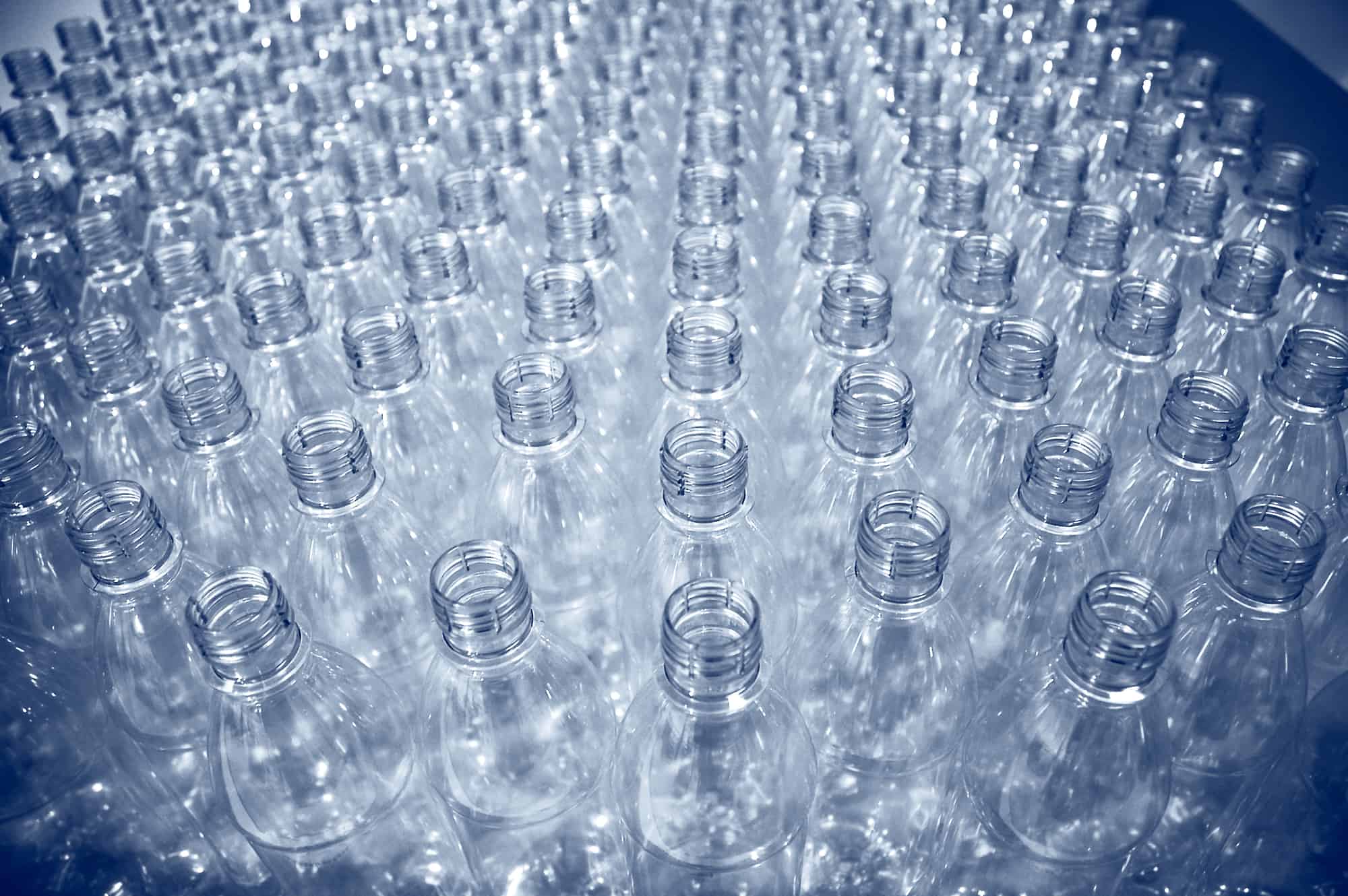 rows of empty plastic bottles at bottling plant