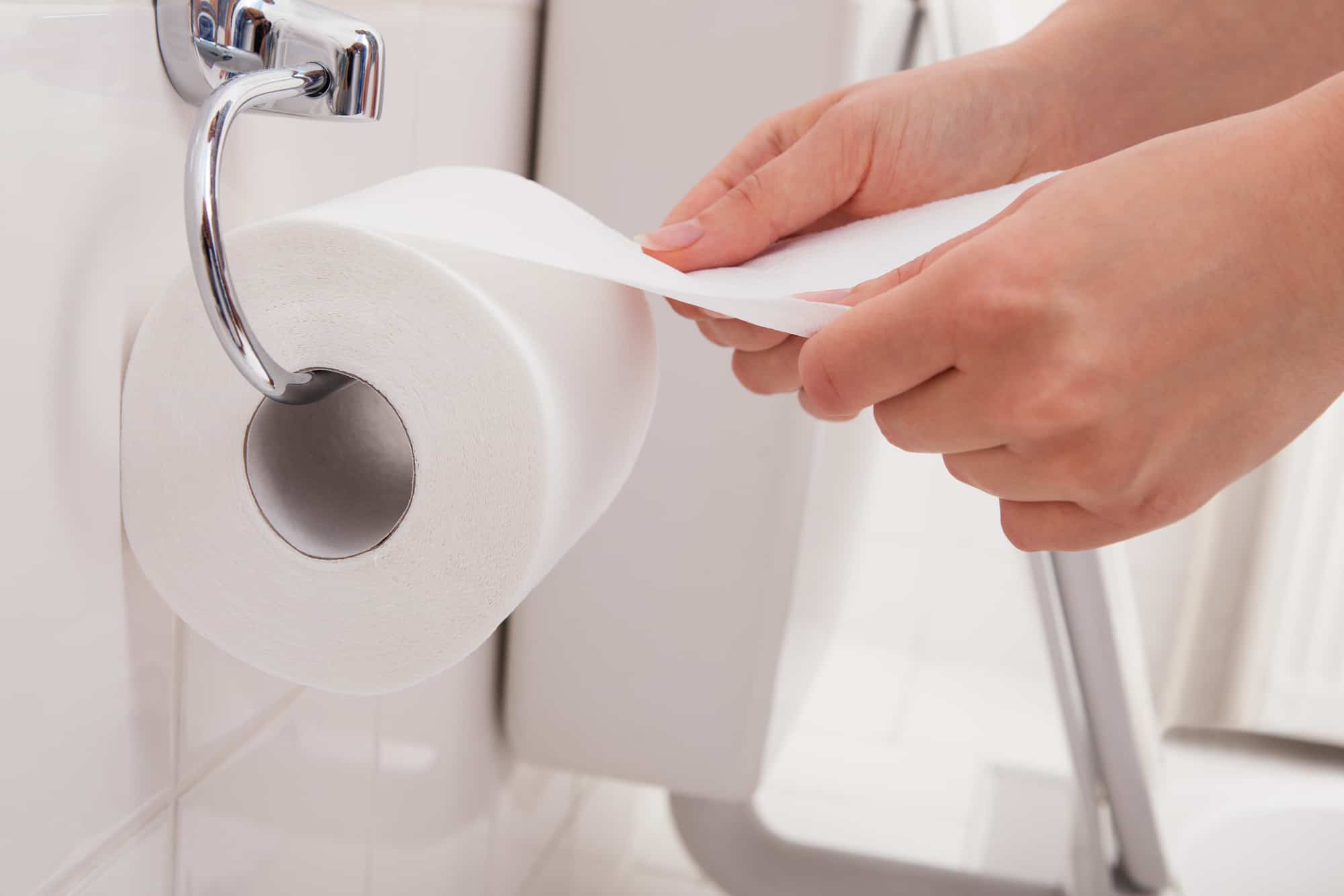 Close-up Of A Person's Hand Using Toilet Paper