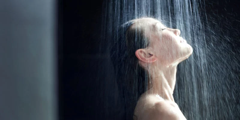 asian woman showering with a shower filter
