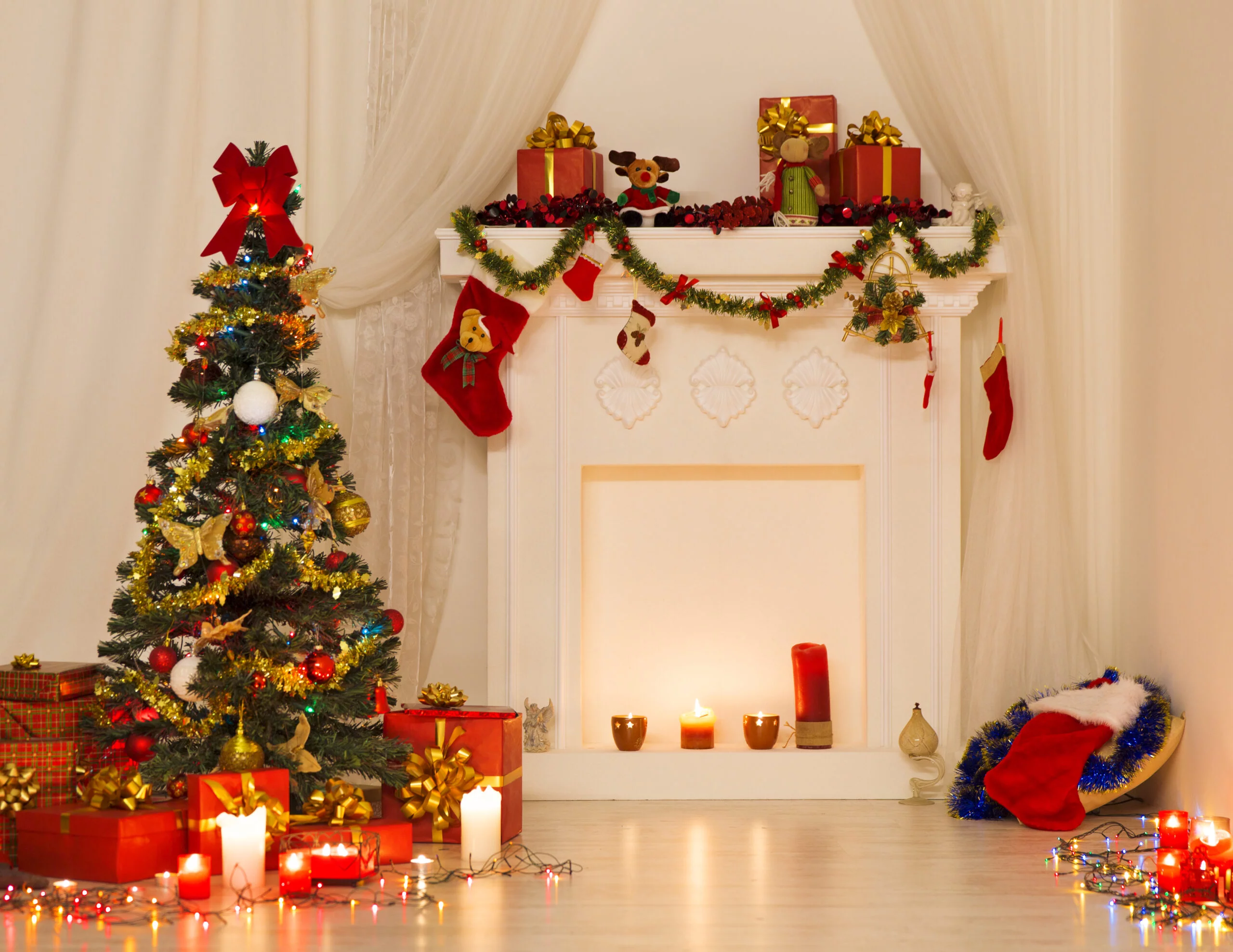 Christmas Room Interior Design, Xmas Tree Decorated By Lights Presents Gifts Toys, Fireplace and Candles Lighting Indoors