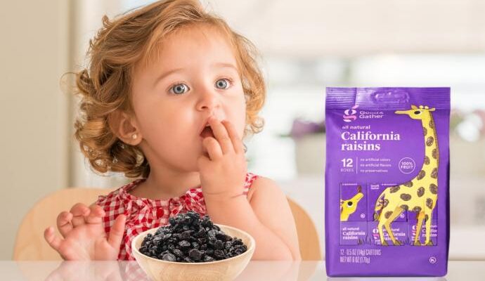 Child eating good and gather raisins from target