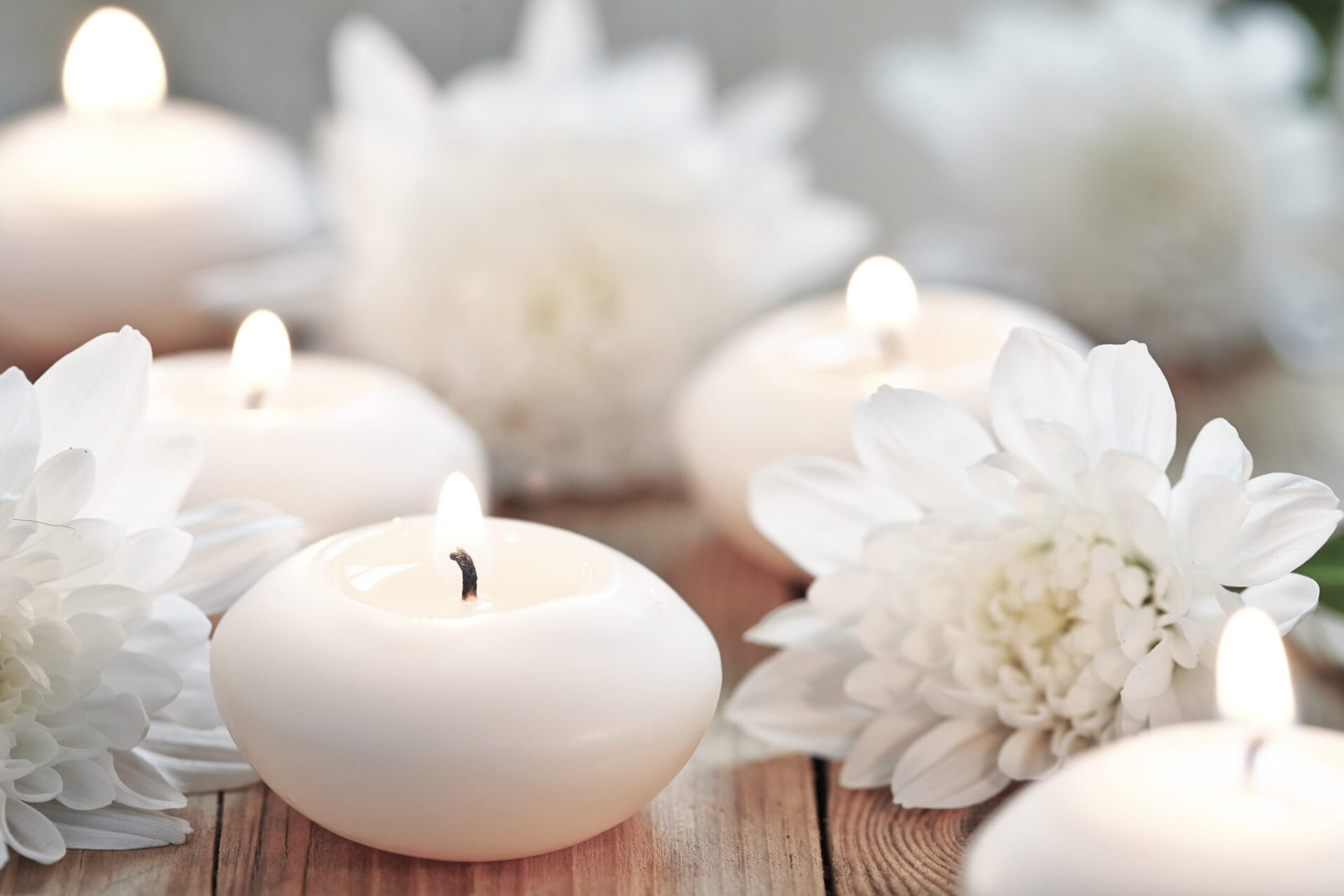 Candles and flowers on wooden table