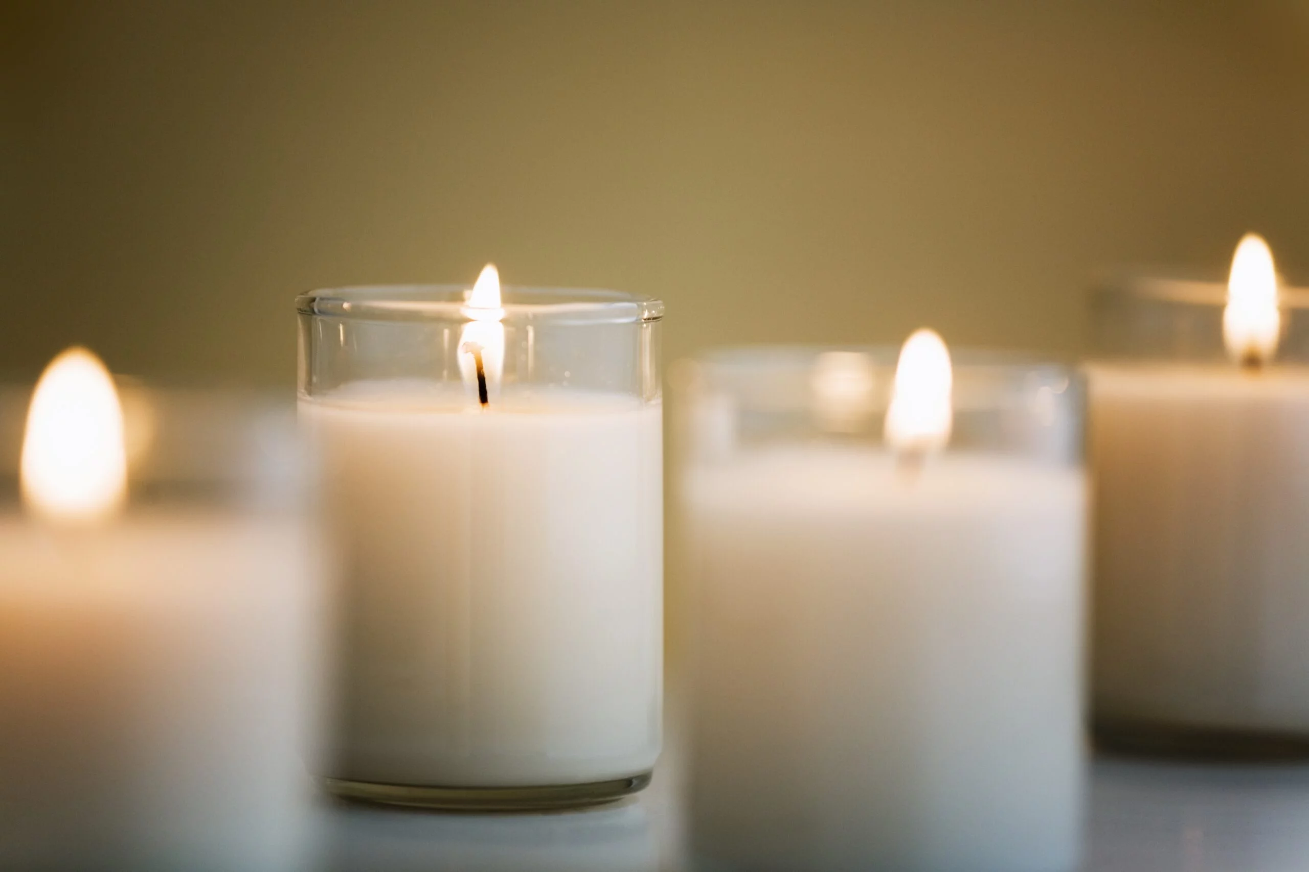 white Candles in glass voltive