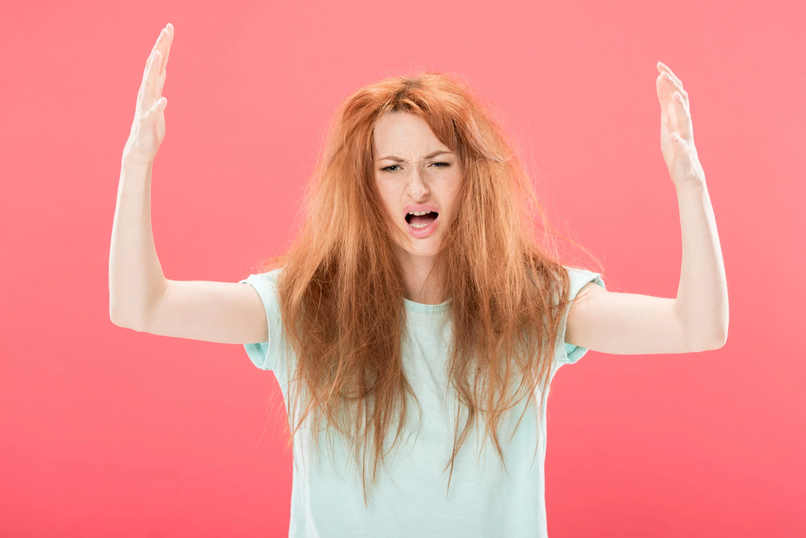 redhead frustrated about her oily hair that needs dry shampoo