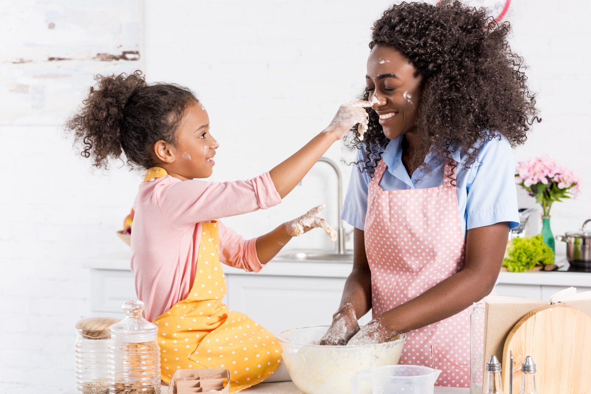 Black mother and daughter baking in the kitchen