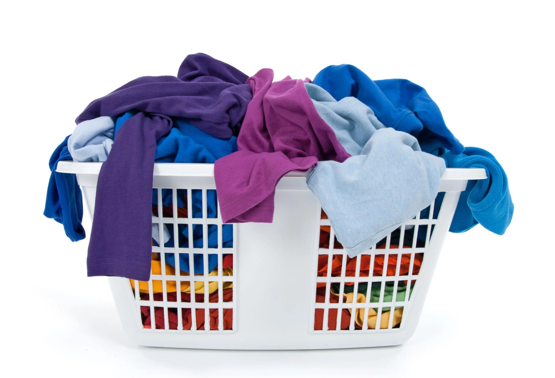 Colorful clothes in a laundry basket on white background