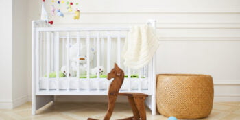 Empty nursery room with basket, toys and wooden horse