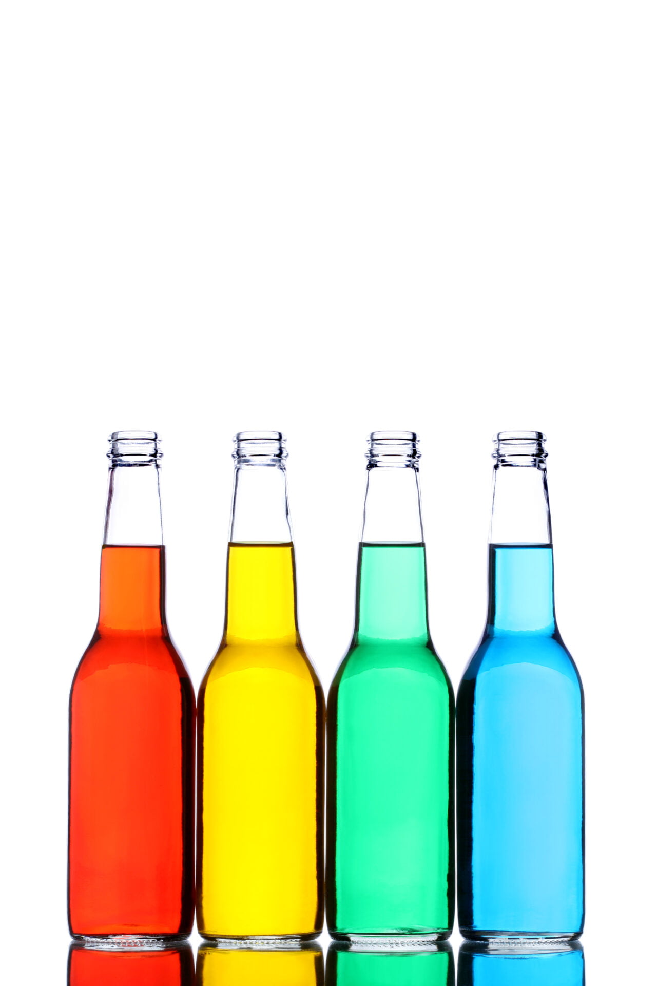 glass bottles with reflection and different colored liquids