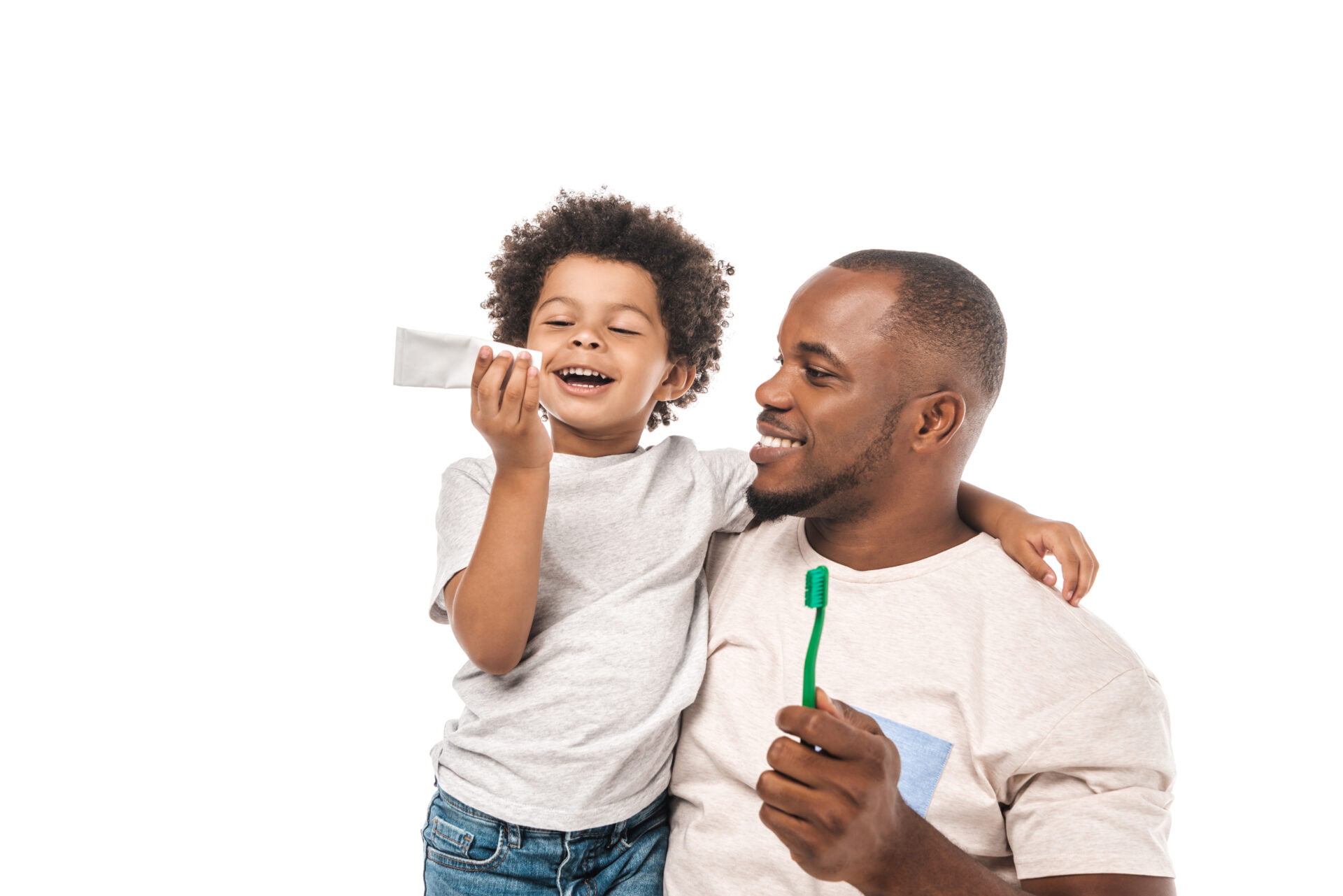 Young black child with father brushing teeth