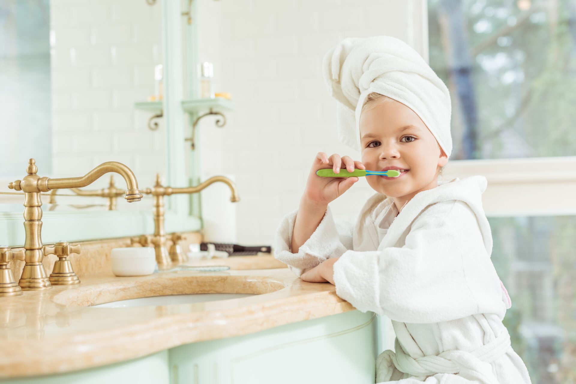small child brushing her teeth