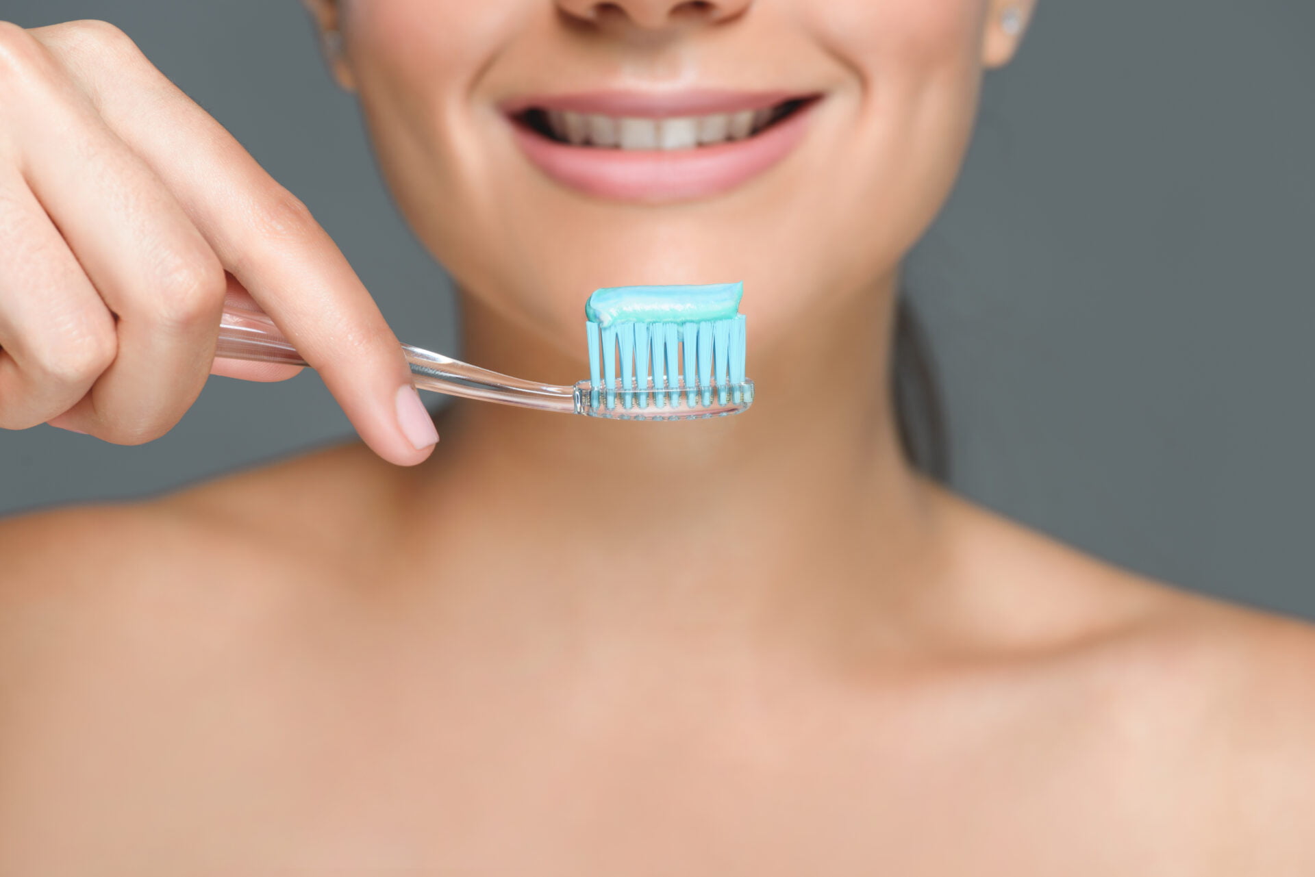 woman about to brush her teeth 
