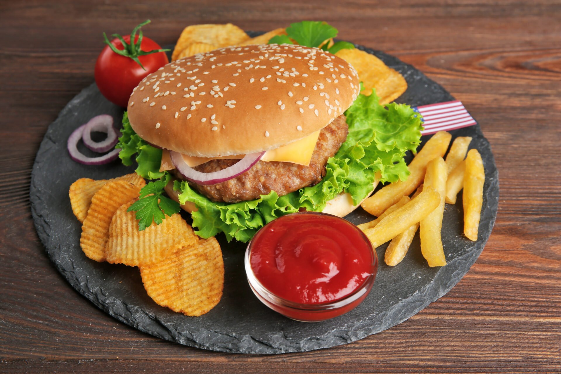 Hamburger with fries on a slate plate