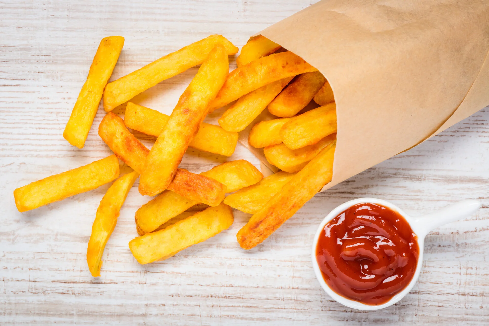Ketchup with Bag of Fried French Fries Potatoes