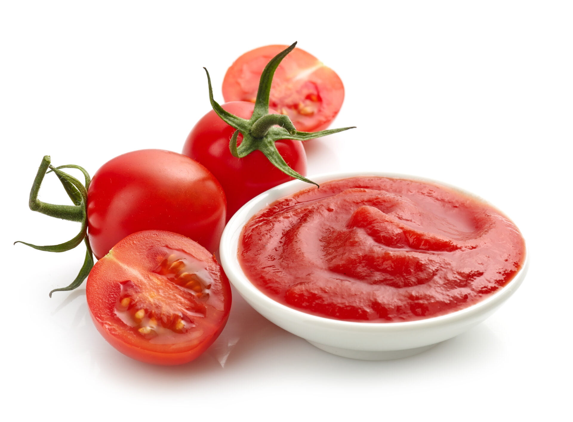 bowl of tomato sauce or ketchup on a white background