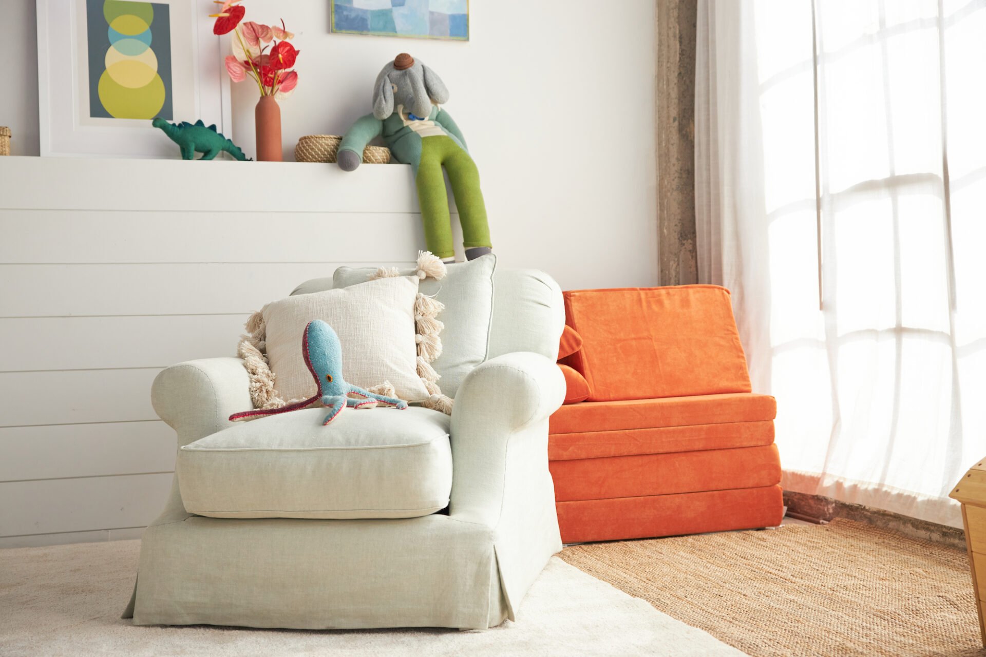 orange foam modular play couch behind white couch