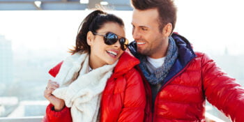 Young couple together at rooftop smiling wearing PFAS free jackets