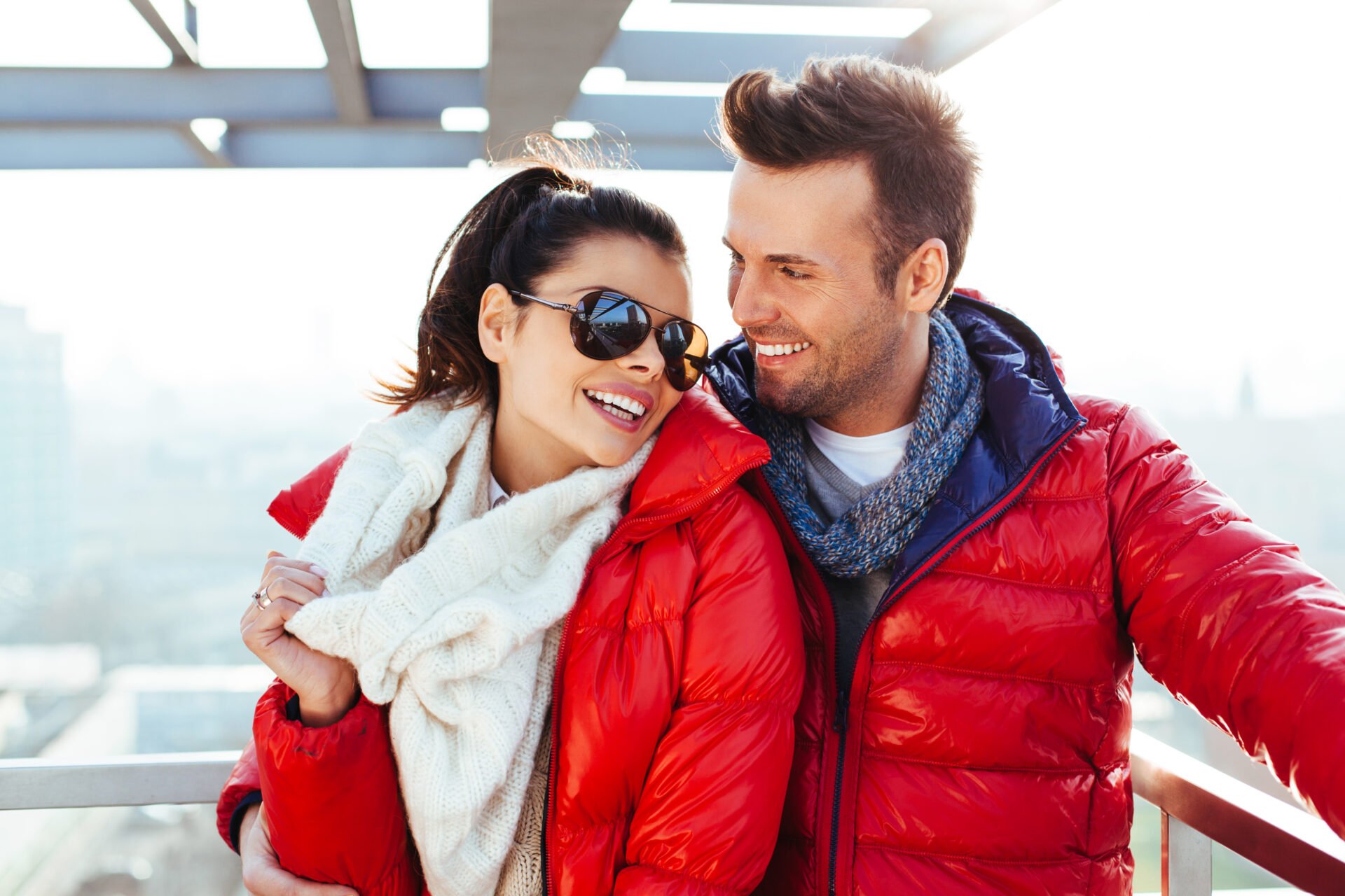 Young couple together at rooftop smiling wearing PFAS free jackets