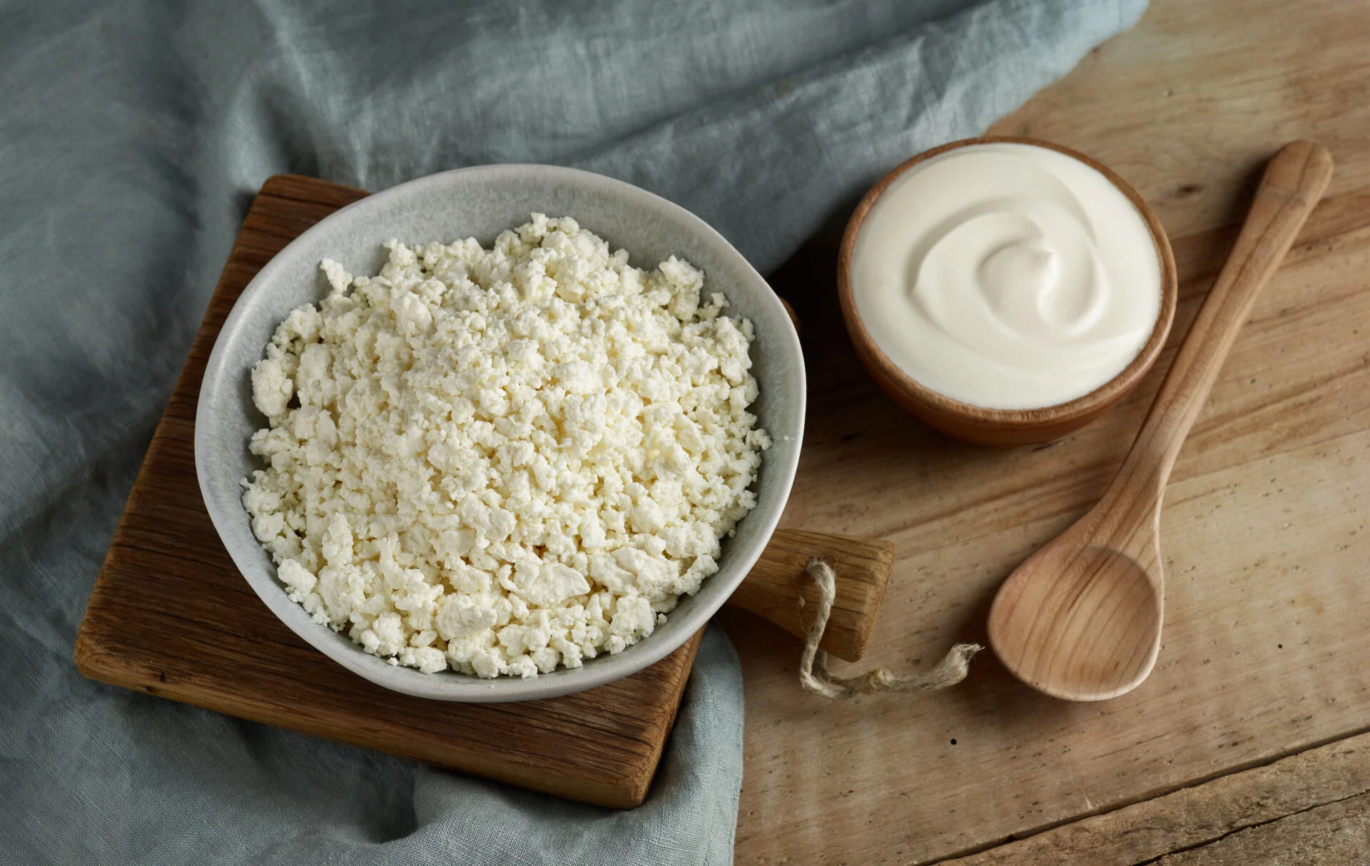 bowl of cottage cheese and sour cream on wooden kitchen table
