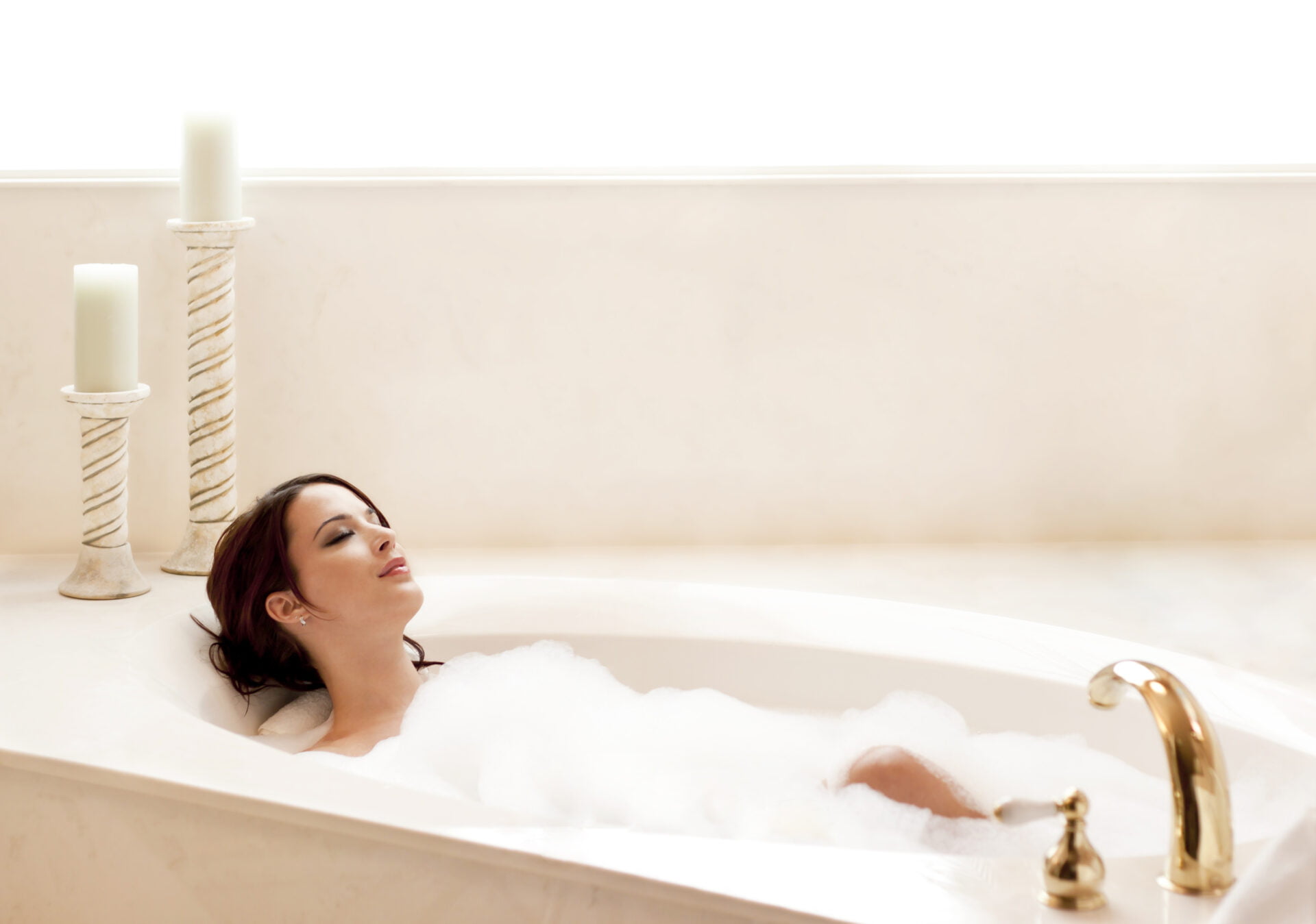 Young attractive woman relaxing in a bubble bath