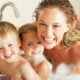 Mother With Children Relaxing In non-toxic Bubble Filled Bath