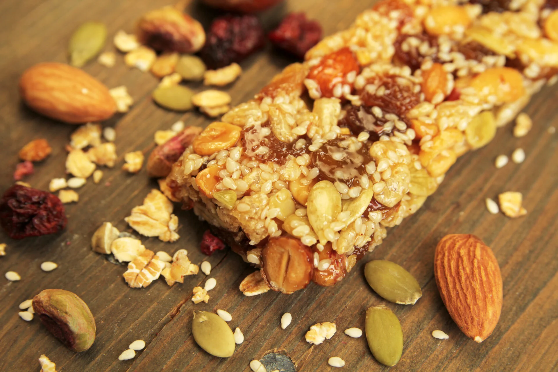 Organic granola bar with nuts and dry fruits on a wooden table
